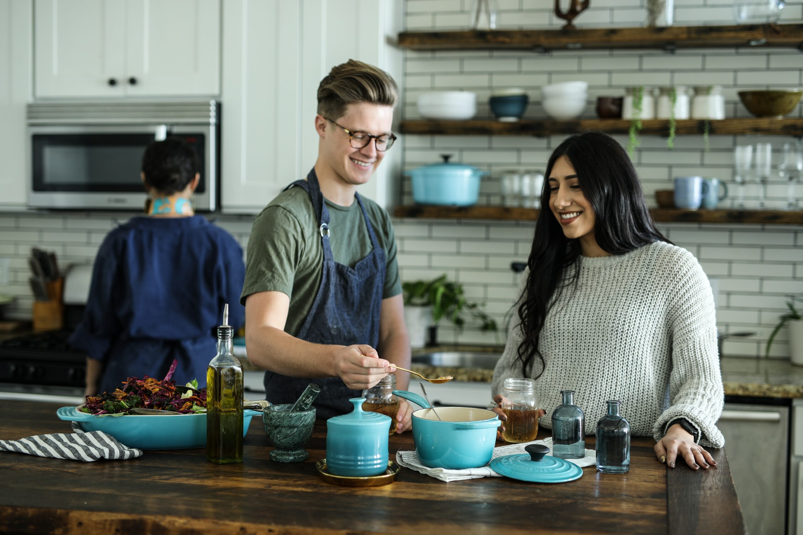 two people cooking in a kitchen using a blue pot and practicing mindfulness